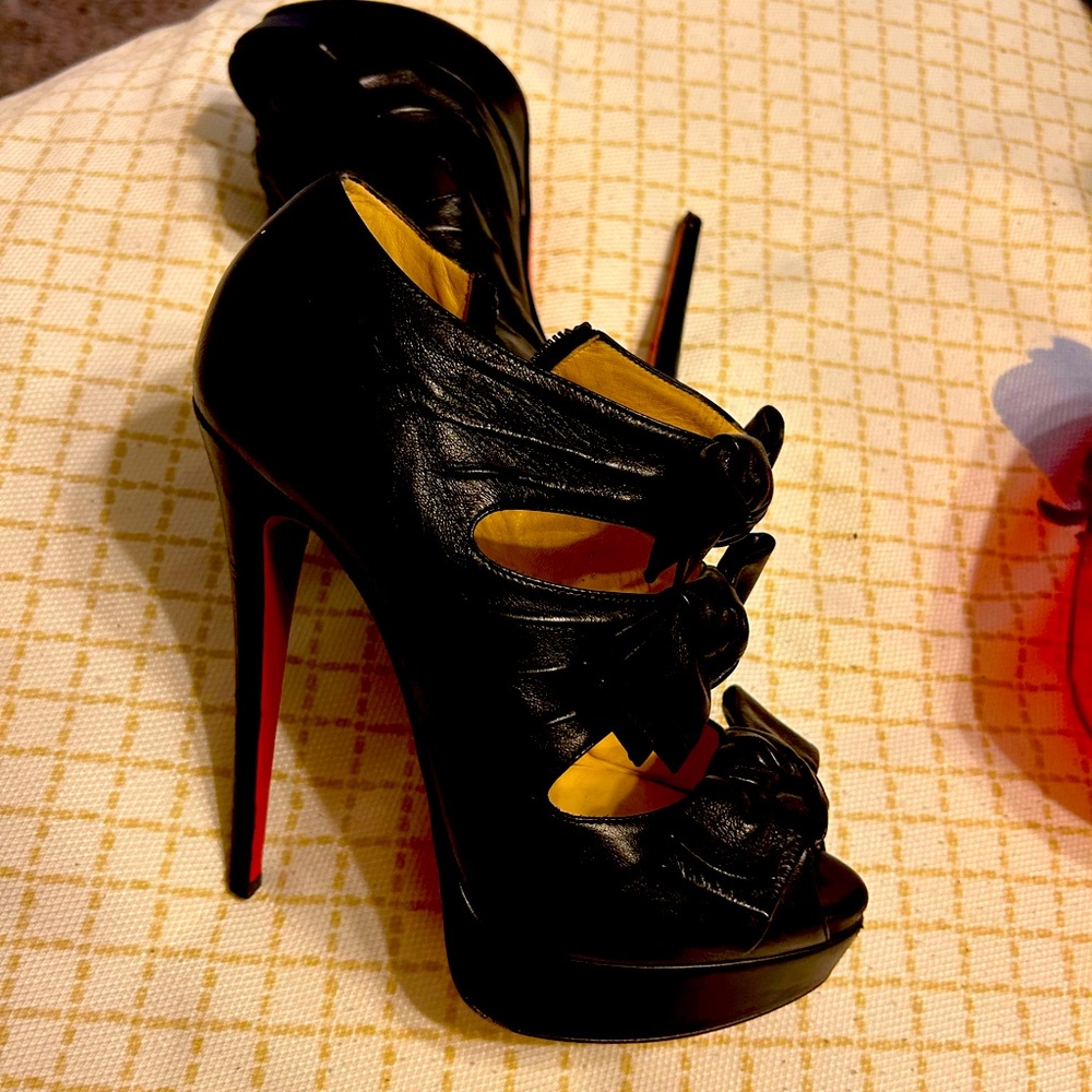 Christian Louboutin peep toe heel with bows.
